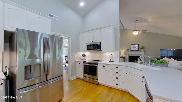 2019 Royal Pines Dr, New Bern, NC 28560 - kitchen featuring appliances with stainless steel finishes, ceiling fan, a sink, light wood finished floors, and light countertops