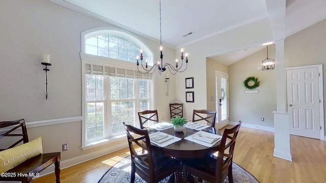 2019 Royal Pines Dr, New Bern, NC 28560 - dining area with a chandelier, light wood finished floors, baseboards, and high vaulted ceiling