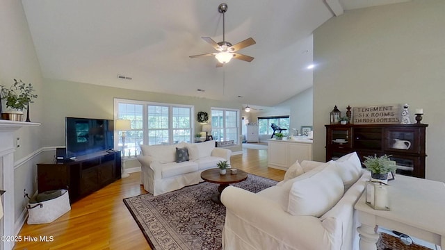 2019 Royal Pines Dr, New Bern, NC 28560 - living area with light wood-type flooring, a ceiling fan, a fireplace, and high vaulted ceiling