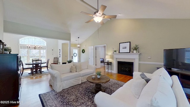 2019 Royal Pines Dr, New Bern, NC 28560 - living room with wood finished floors, a fireplace, ceiling fan, a chandelier, and high vaulted ceiling