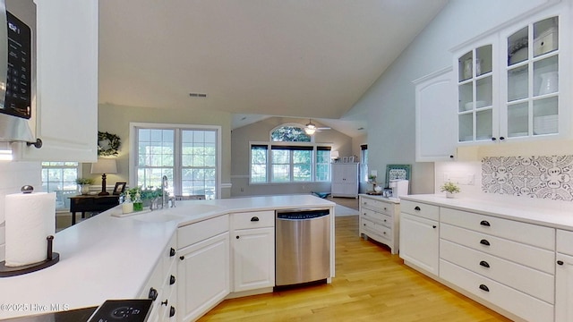 2019 Royal Pines Dr, New Bern, NC 28560 - kitchen with appliances with stainless steel finishes, a sink, backsplash, vaulted ceiling, and light wood-type flooring