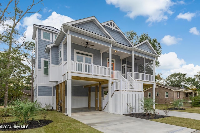 1605 E Oak Island Dr, Oak Island, NC 28465 - view of front of property with a ceiling fan, driveway, stairway, and a carport