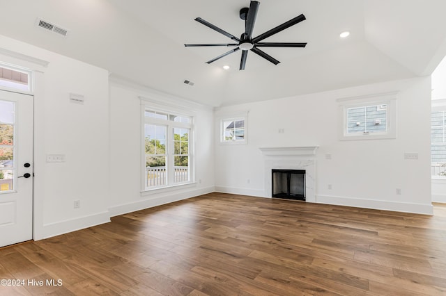 1605 E Oak Island Dr, Oak Island, NC 28465 - unfurnished living room with a ceiling fan, a high end fireplace, wood finished floors, lofted ceiling, and baseboards