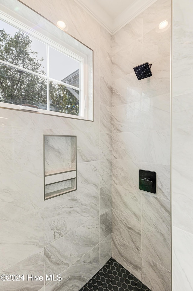1605 E Oak Island Dr, Oak Island, NC 28465 - bathroom featuring tiled shower, ornamental molding, and healthy amount of natural light
