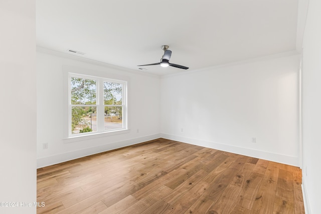 1605 E Oak Island Dr, Oak Island, NC 28465 - empty room with crown molding, a ceiling fan, wood finished floors, and baseboards