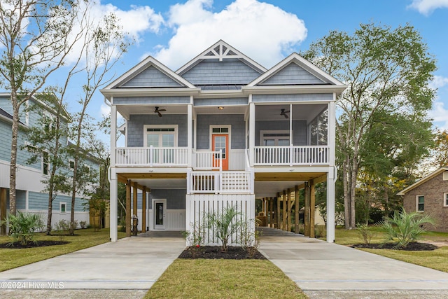 1605 E Oak Island Dr, Oak Island, NC 28465 - raised beach house with a carport, a ceiling fan, and driveway