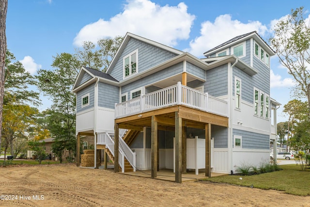 1605 E Oak Island Dr, Oak Island, NC 28465 - back of property featuring a wooden deck and stairway