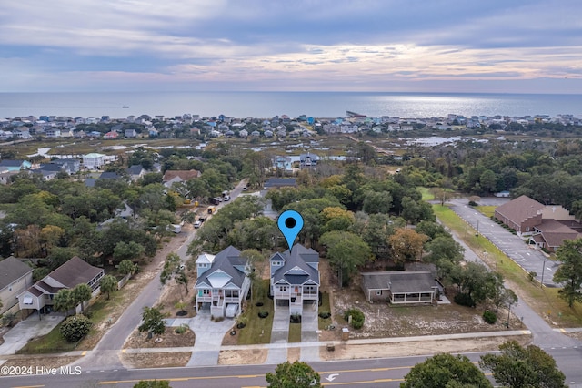 1605 E Oak Island Dr, Oak Island, NC 28465 - aerial view at dusk of a water view, a residential view, and view of scattered trees