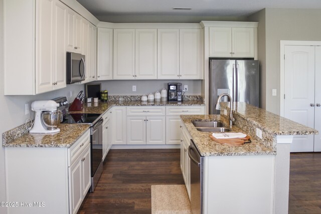 284 Old Swamp Rd, South Mills, NC 27976 - kitchen featuring stainless steel appliances, a sink, a kitchen island with sink, dark wood-style flooring, and white cabinets