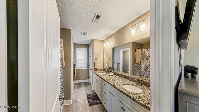 284 Old Swamp Rd, South Mills, NC 27976 - bathroom with vanity, wood finished floors, and baseboards