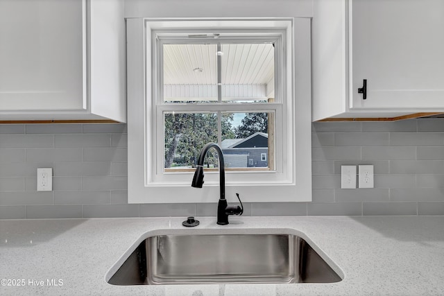 340 Persimmon Rd SW, Calabash, NC 28467 - kitchen featuring decorative backsplash and white cabinets