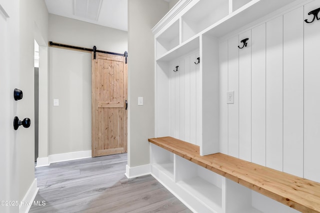 340 Persimmon Rd SW, Calabash, NC 28467 - mudroom featuring a barn door and light wood-type flooring