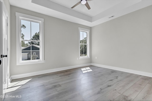 340 Persimmon Rd SW, Calabash, NC 28467 - spare room with a raised ceiling, plenty of natural light, a ceiling fan, and wood finished floors