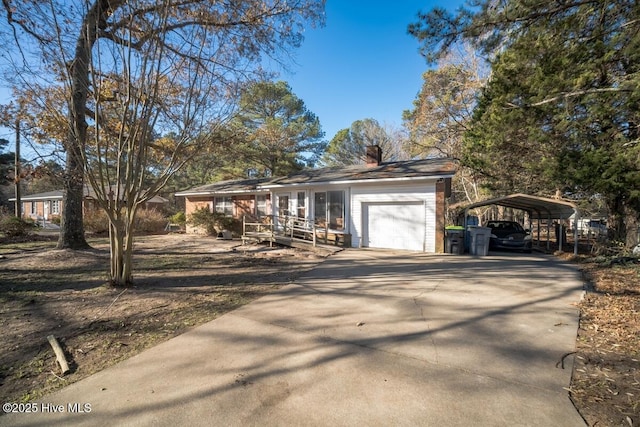 10179 NC Highway 305, Jackson, NC 27845 - ranch-style home with a chimney, a detached carport, driveway, and an attached garage