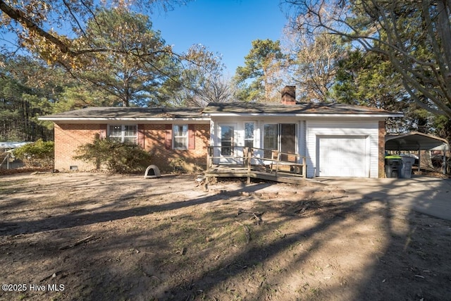 10179 NC Highway 305, Jackson, NC 27845 - ranch-style house featuring a chimney, a carport, a wooden deck, brick siding, and an attached garage