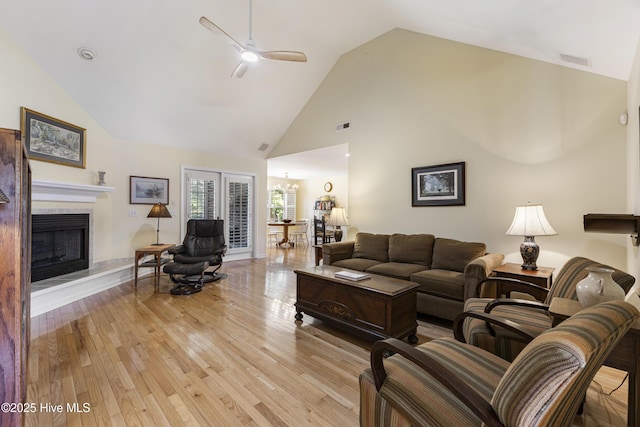 3863 Daphine Ct, Wilmington, NC 28409 - living area with light wood-style flooring, high vaulted ceiling, ceiling fan, and a fireplace with raised hearth