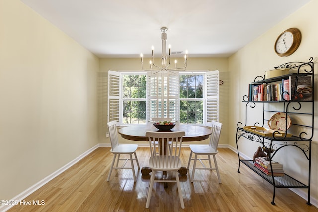 3863 Daphine Ct, Wilmington, NC 28409 - dining area featuring a chandelier, light wood-type flooring, and baseboards