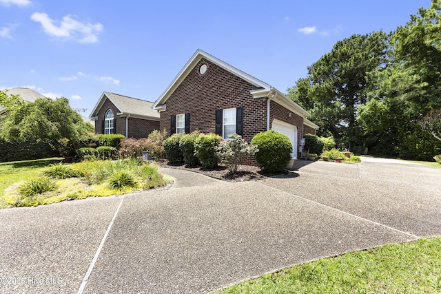 3863 Daphine Ct, Wilmington, NC 28409 - view of home's exterior featuring brick siding, a garage, and driveway
