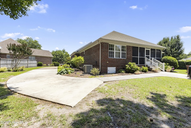 3863 Daphine Ct, Wilmington, NC 28409 - view of front facade featuring a sunroom, central AC unit, and brick siding