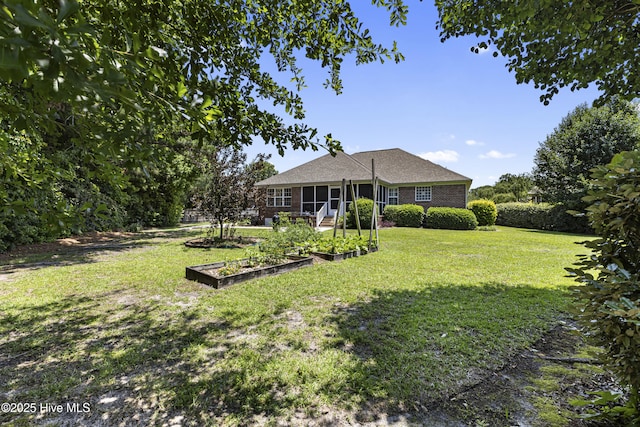 3863 Daphine Ct, Wilmington, NC 28409 - view of green lawn with a vegetable garden
