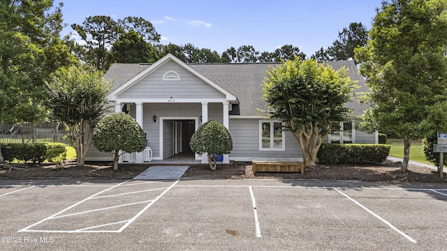 3863 Daphine Ct, Wilmington, NC 28409 - view of front of property with roof with shingles, uncovered parking, and a porch