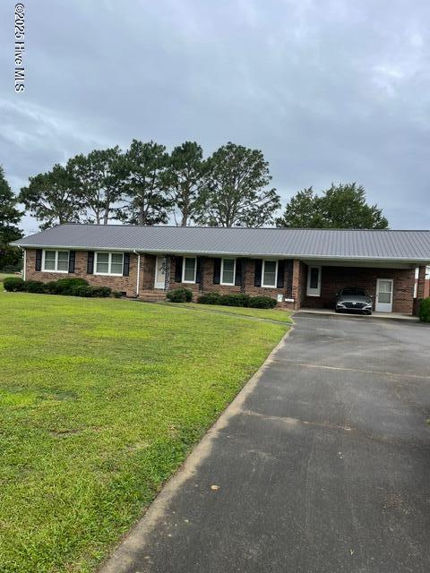 7584 County Home Rd, Ayden, NC 28513 - ranch-style home with asphalt driveway, a carport, a front yard, and metal roof