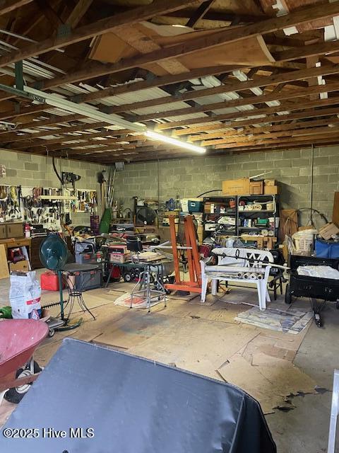 7584 County Home Rd, Ayden, NC 28513 - garage featuring a workshop area and concrete block wall