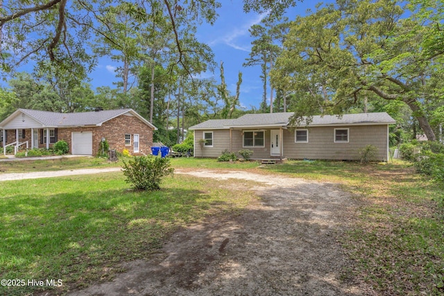 214 Frink Dr, Southport, NC 28461 - ranch-style home with driveway, a front lawn, and a garage