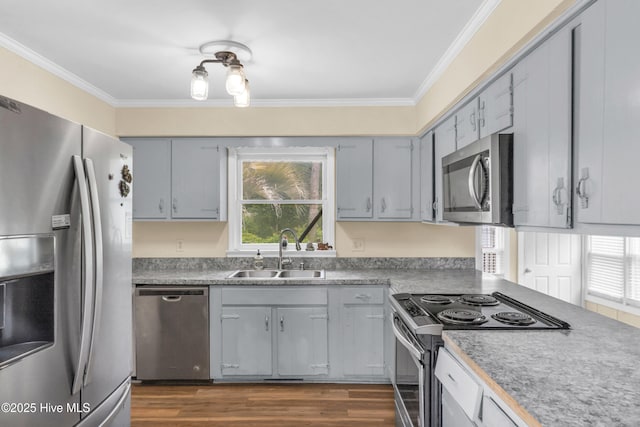 214 Frink Dr, Southport, NC 28461 - kitchen with stainless steel appliances, a sink, crown molding, healthy amount of natural light, and dark wood-style floors