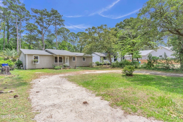 214 Frink Dr, Southport, NC 28461 - single story home with curved driveway, a front yard, and crawl space