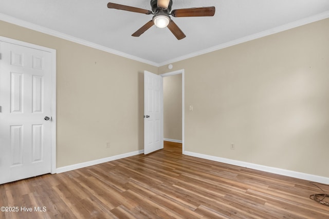 214 Frink Dr, Southport, NC 28461 - unfurnished bedroom featuring baseboards, wood finished floors, ornamental molding, and ceiling fan
