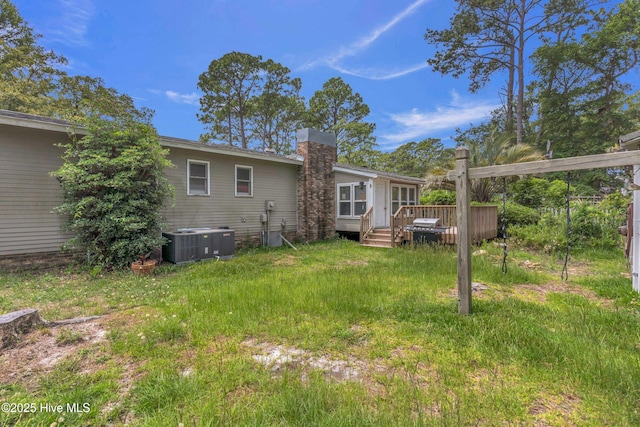 214 Frink Dr, Southport, NC 28461 - rear view of property with cooling unit, a wooden deck, and a chimney