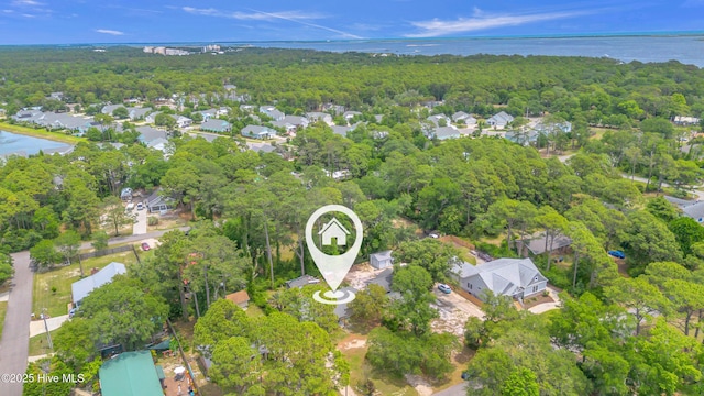 214 Frink Dr, Southport, NC 28461 - aerial overview of property's location with a heavily wooded area, nearby suburban area, and a large body of water