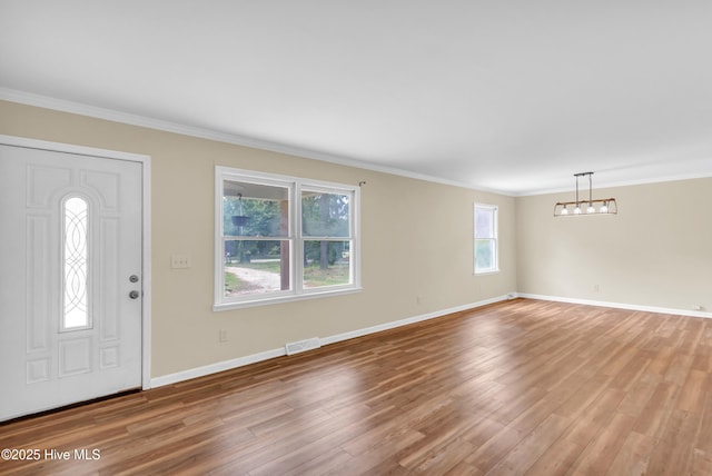214 Frink Dr, Southport, NC 28461 - entryway featuring light wood-style flooring, baseboards, and crown molding