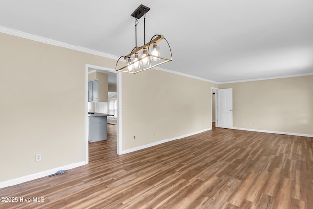 214 Frink Dr, Southport, NC 28461 - unfurnished room featuring a chandelier, ornamental molding, wood finished floors, and baseboards