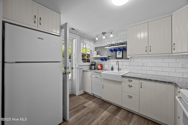 207 Battleground Ave, New Bern, NC 28560 - kitchen featuring white appliances, wood finished floors, backsplash, light stone counters, and white cabinetry