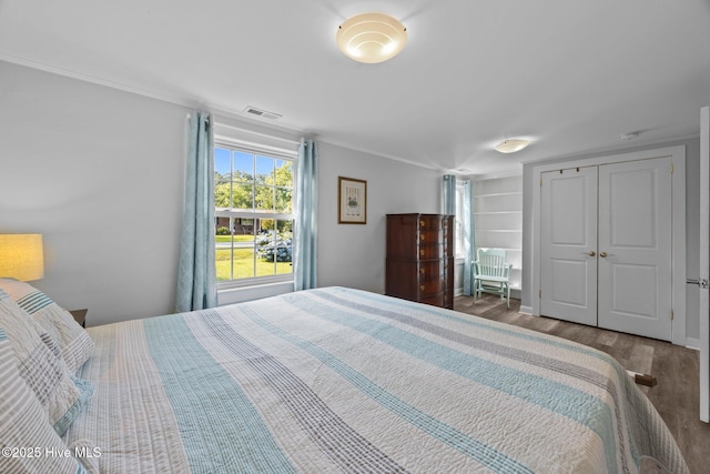 207 Battleground Ave, New Bern, NC 28560 - bedroom featuring wood finished floors, a closet, and ornamental molding