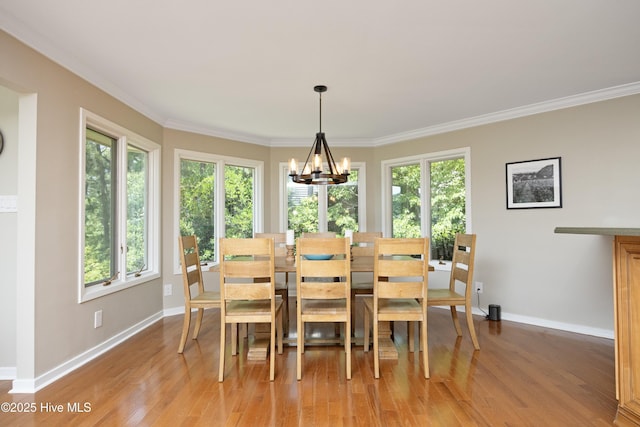 467 Longleaf Dr, West End, NC 27376 - dining area featuring plenty of natural light, light wood-style flooring, a chandelier, baseboards, and crown molding