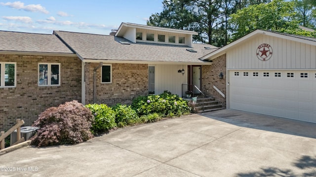 467 Longleaf Dr, West End, NC 27376 - view of front of home featuring roof with shingles, driveway, brick siding, and an attached garage