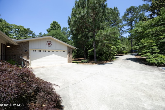 467 Longleaf Dr, West End, NC 27376 - view of side of property featuring concrete driveway, brick siding, and a garage