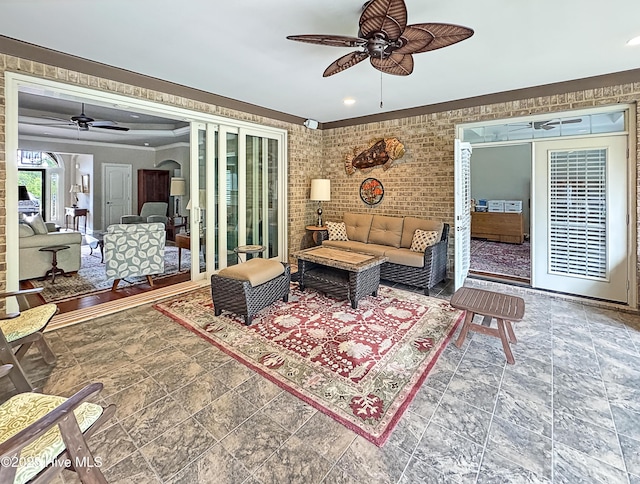 6003 Mount Carmel Parke, Wilmington, NC 28412 - living room featuring ceiling fan, stone finish flooring, recessed lighting, crown molding, and brick wall