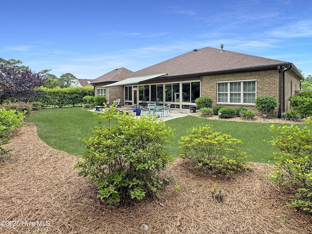 6003 Mount Carmel Parke, Wilmington, NC 28412 - back of house with brick siding, a patio, and a lawn