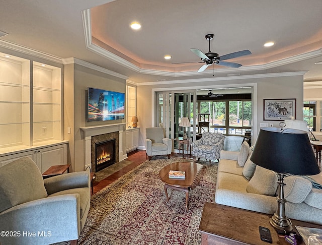 6003 Mount Carmel Parke, Wilmington, NC 28412 - living room featuring a raised ceiling, a fireplace, ornamental molding, ceiling fan, and recessed lighting