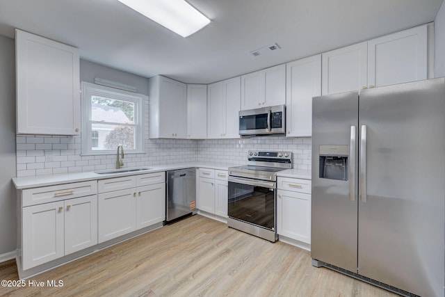 326 Cathay Rd, Wilmington, NC 28412 - kitchen with stainless steel appliances, a sink, light wood-style floors, and light countertops