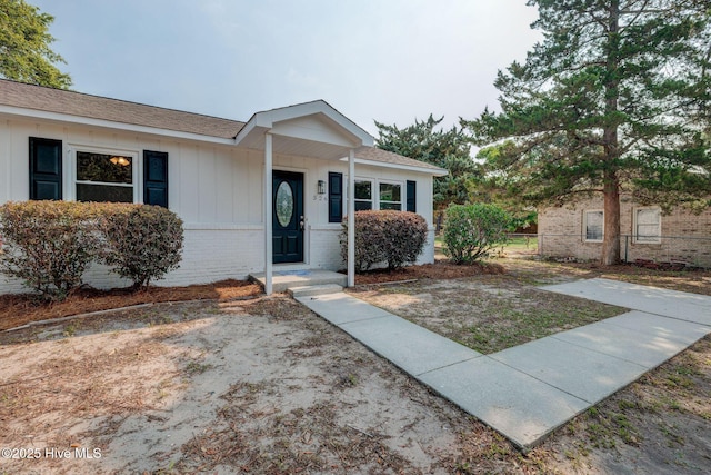 326 Cathay Rd, Wilmington, NC 28412 - ranch-style home with brick siding, board and batten siding, and a shingled roof