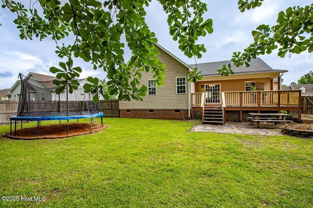 109 Hilda Dr, New Bern, NC 28562 - rear view of house featuring a trampoline, crawl space, a fenced backyard, a deck, and a patio area
