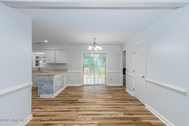 109 Hilda Dr, New Bern, NC 28562 - unfurnished dining area with a chandelier, light wood-type flooring, and recessed lighting