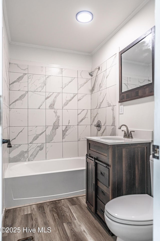 1103 Hylan Ave, Hamlet, NC 28345 - full bath with toilet, ornamental molding, vanity,  shower combination, and wood finished floors