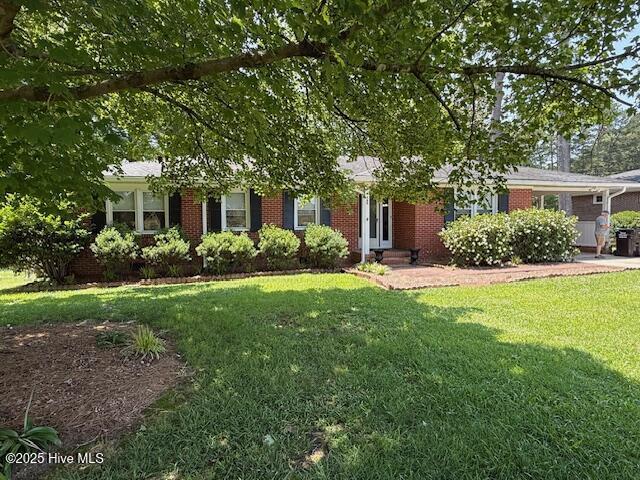 780 Leslie Campbell Ave, Lillington, NC 27546 - view of front of home with a front yard, brick siding, entry steps, and an attached garage