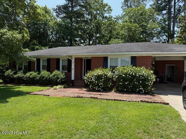 780 Leslie Campbell Ave, Lillington, NC 27546 - single story home featuring brick siding, a front yard, concrete driveway, and a carport